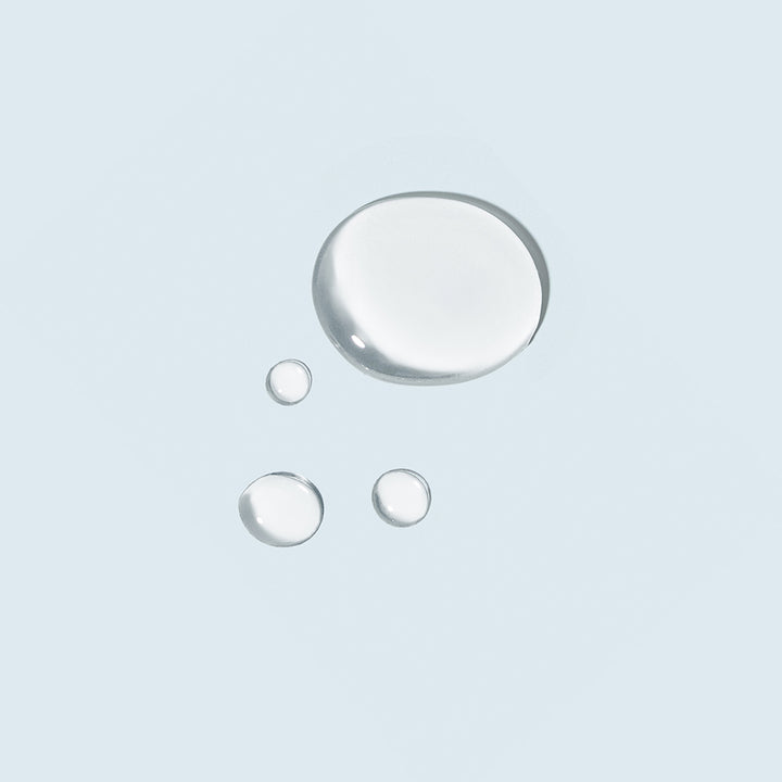tizo advanced vitamin c + e serum product swatch on light blue background.