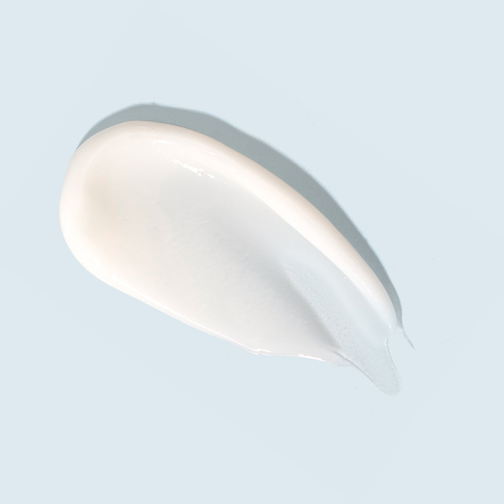 TiZO Complexion Brightener swatch on light blue background.