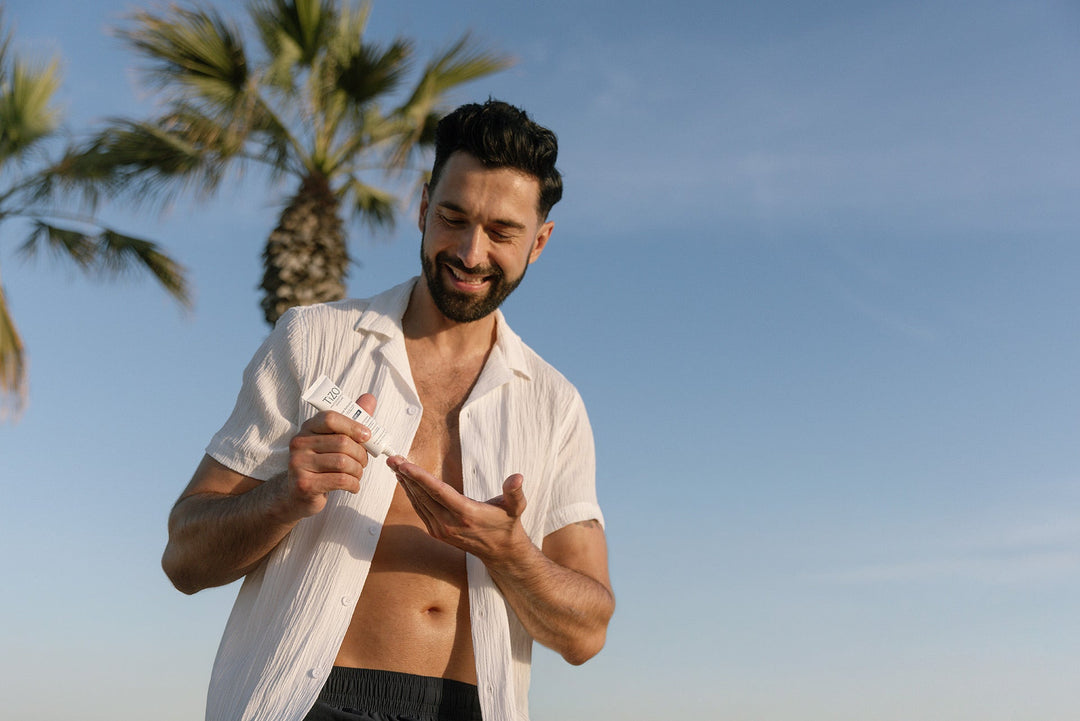 Man applying mineral sunscreen to his face during his morning routine