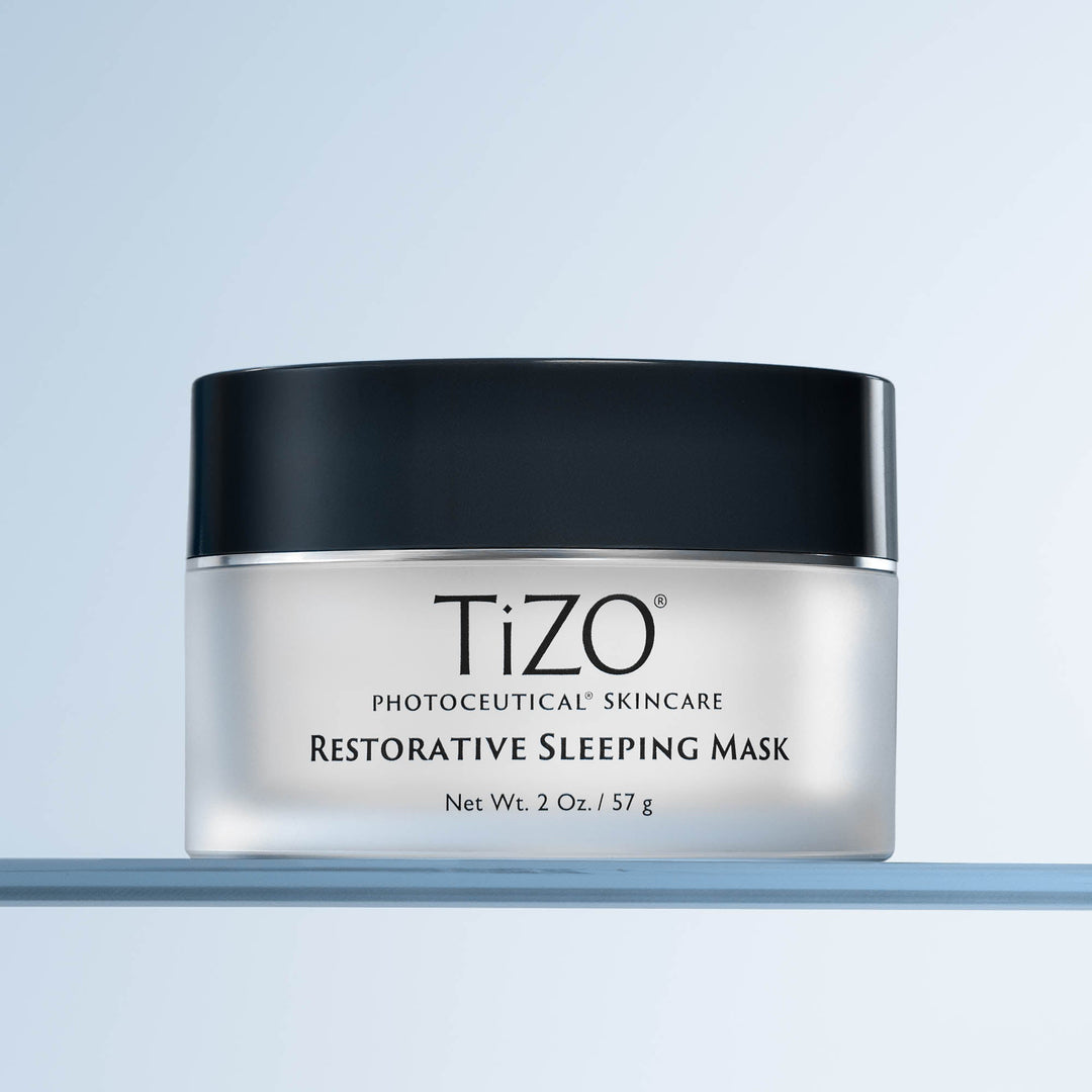 image of tizo restorative sleeping mask container on a gradient blue to white background
