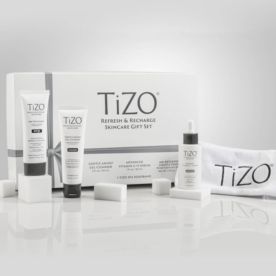 TiZO Refresh & Recharge Skincare Gift Set box, TiZO AM Replenish Lightly Tinted tube, TiZO Gentle Amino Gel Cleanser tube, TiZO Advanced Vitamin C + E Serum bottle and TiZO headband.