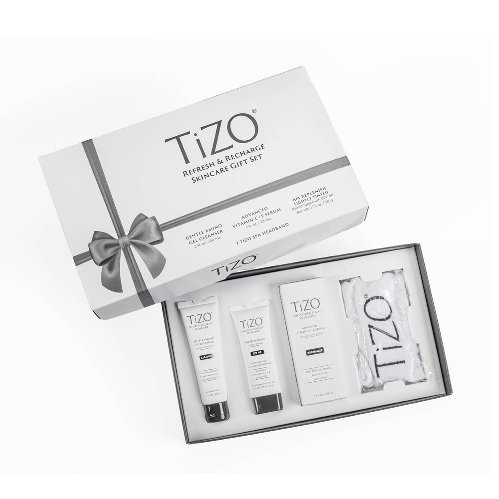 Opened TiZO Refresh & Recharge Skincare Gift Set box, TiZO AM Replenish Lightly Tinted tube, TiZO Gentle Amino Gel Cleanser tube, TiZO Advanced Vitamin C + E Serum bottle and TiZO headband.