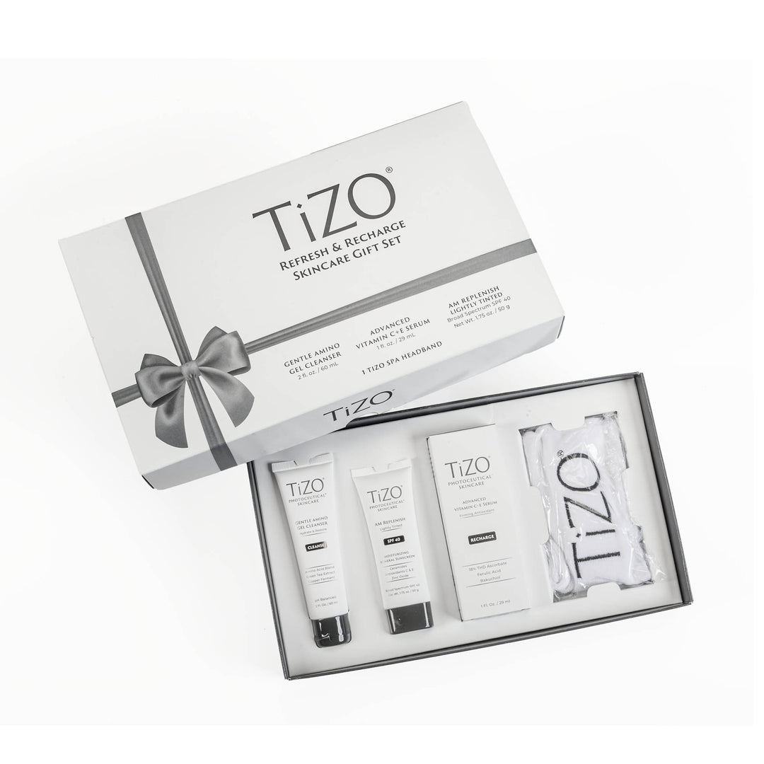 Opened TiZO Refresh & Recharge Skincare Gift Set box, TiZO AM Replenish Lightly Tinted tube, TiZO Gentle Amino Gel Cleanser tube, TiZO Advanced Vitamin C + E Serum bottle and TiZO headband.