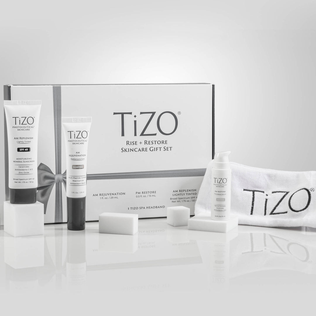 TiZO Rise + Restore Skincare Gift Set box, TiZO AM Replenish Lightly Tinted tube, TiZO AM Rejuvenation tube, open cap TiZO Eye Renewal Non-Tinted bottle and TiZO headband.