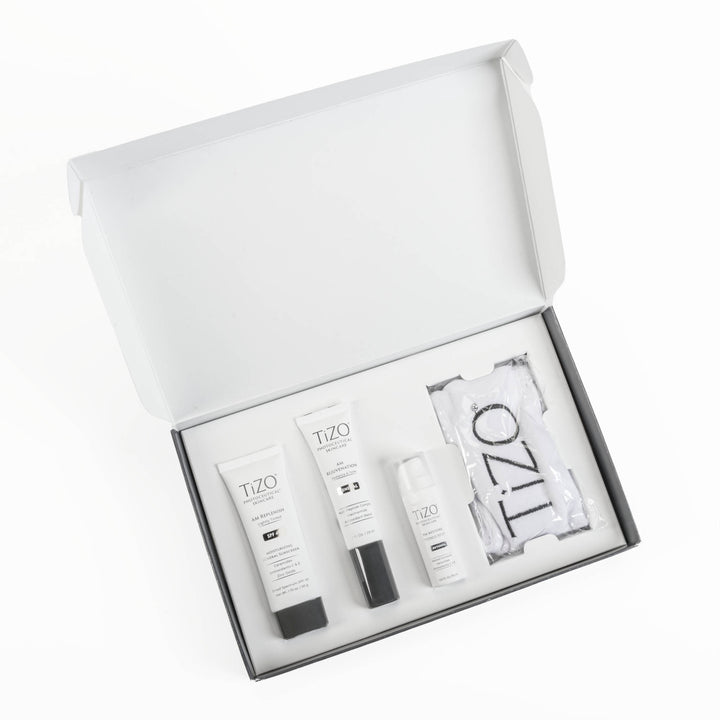 Opened TiZO Rise + Restore Skincare Gift Set box, TiZO AM Replenish Lightly Tinted tube, TiZO AM Rejuvenation tube, open cap TiZO Eye Renewal Non-Tinted bottle and TiZO headband.